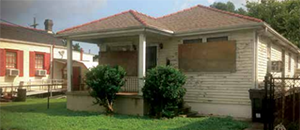 Before: A distressed bungalow before it was rehabilitated by Redmellon Restoration & Development, a real estate development company in New Orleans. (Redmellon Restoration & Development)